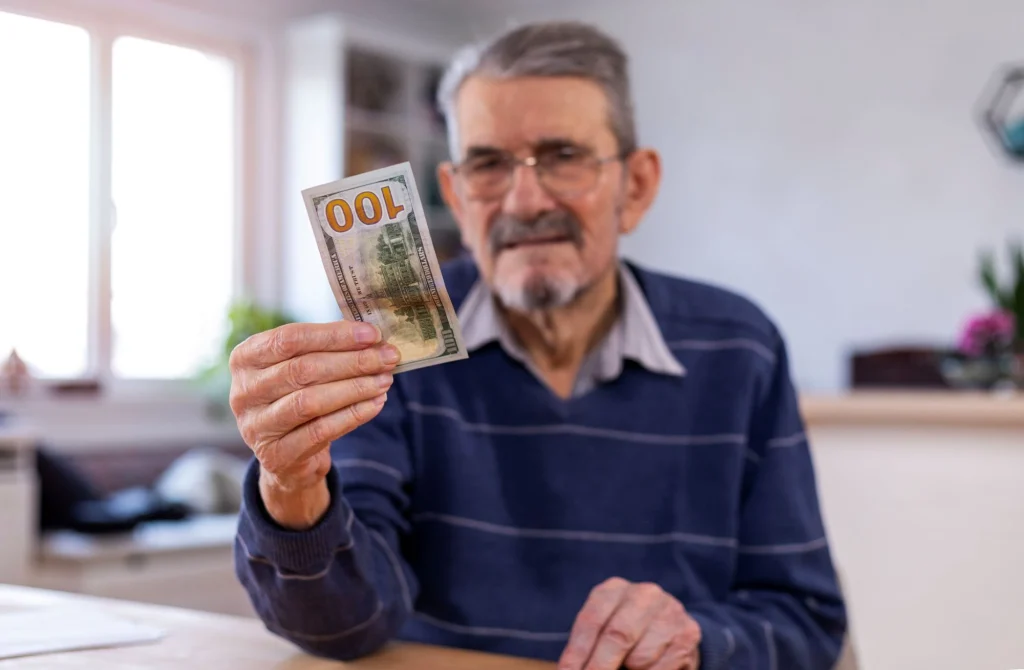 older man with dollar bills
