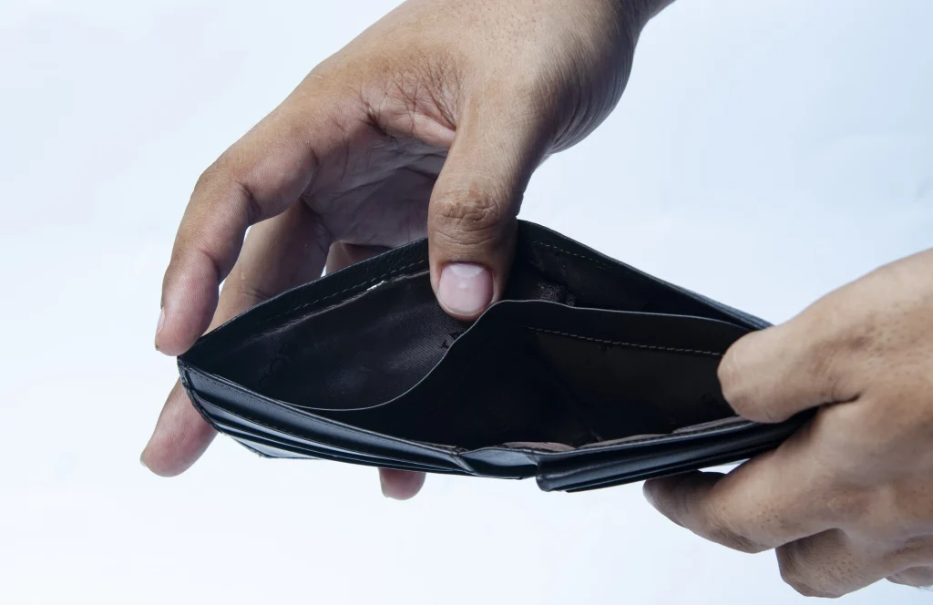 hands holding an empty wallet symbolizing not enough money