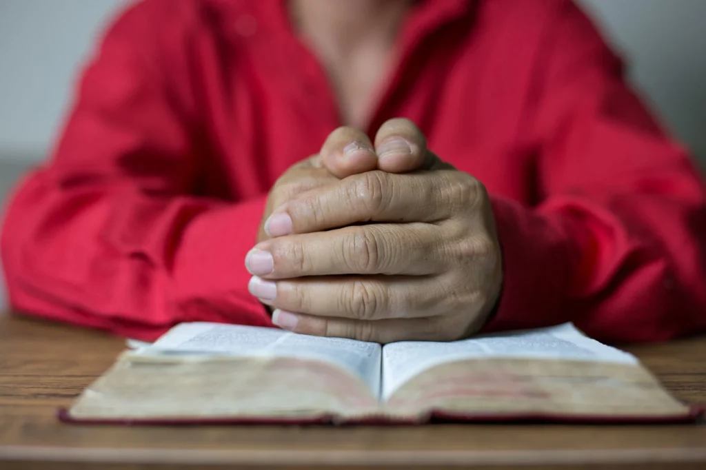 praying hands on bible
