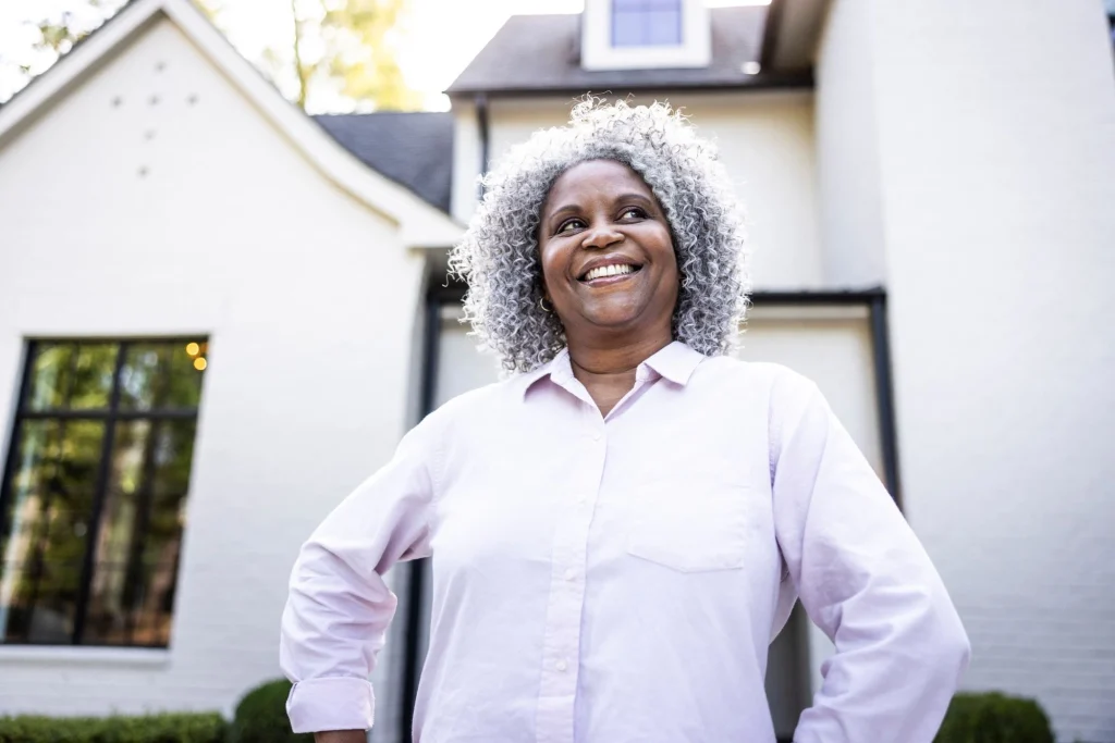 lady posing in front of her home