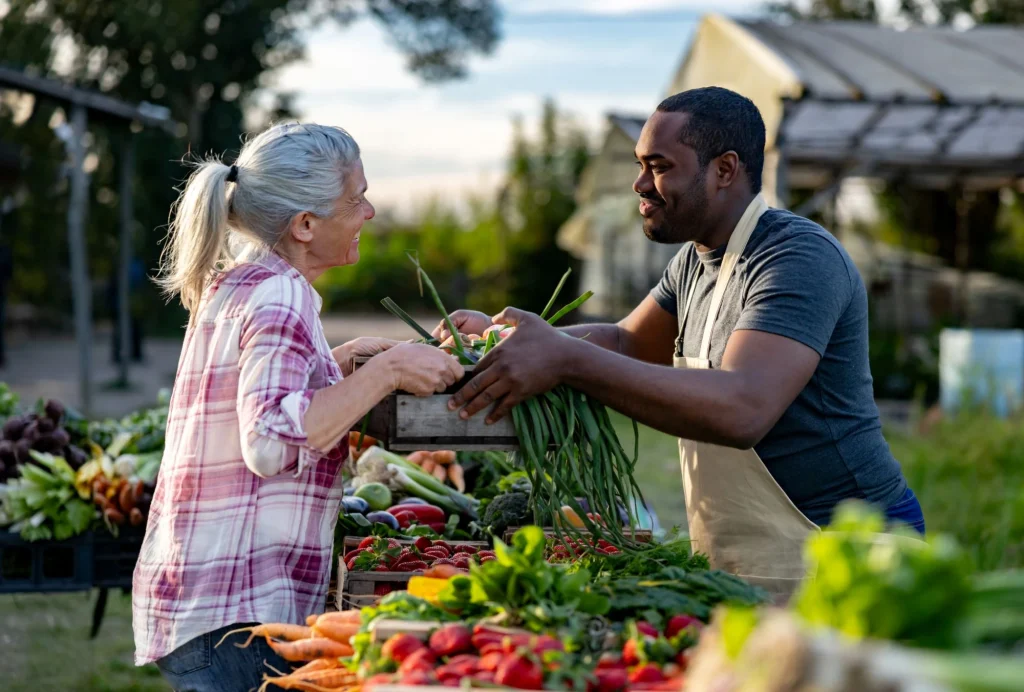 older lady with a man shopping farmer's market