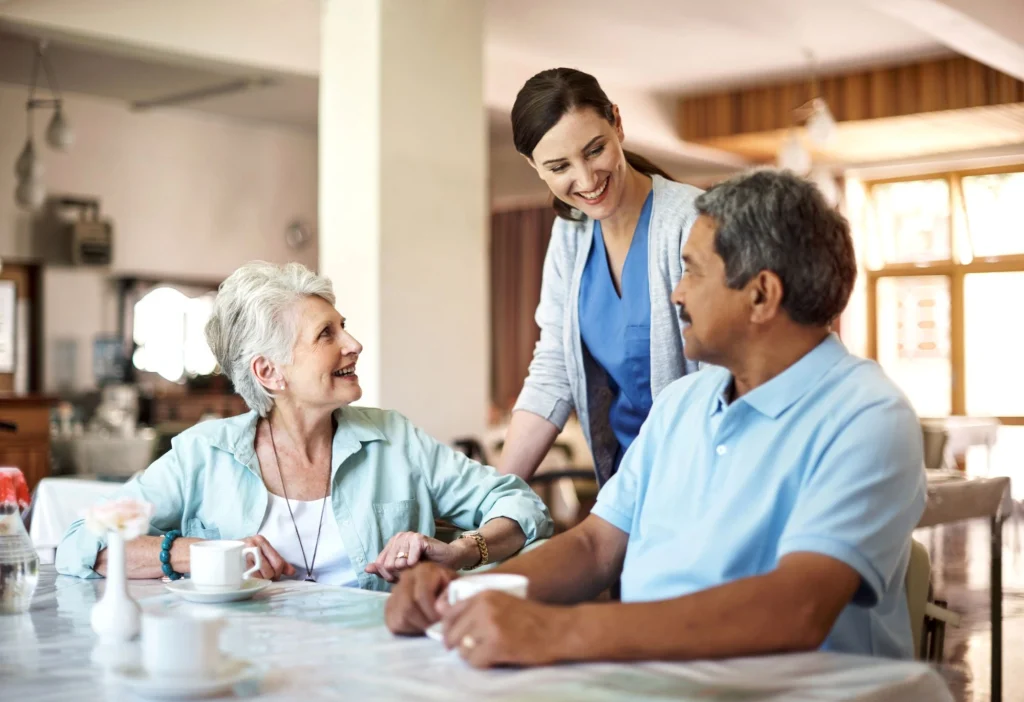 participants of adult day care chatting with nurse over tea
