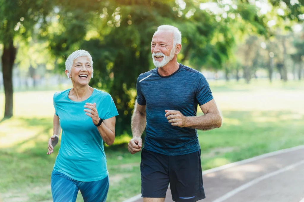 older couple jogging outdoors in the park