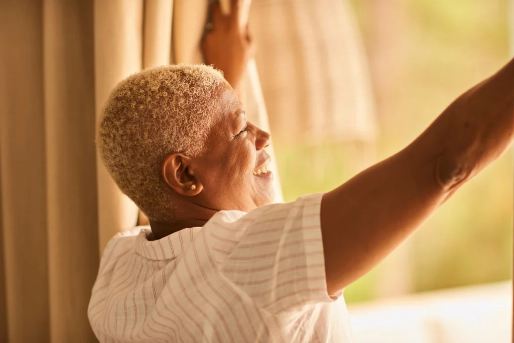 lady staring outside bathed in sunlight change and growth