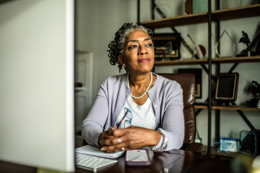 older lady pensive at laptop