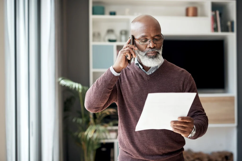 older man on the phone signing up for auto insurance discount