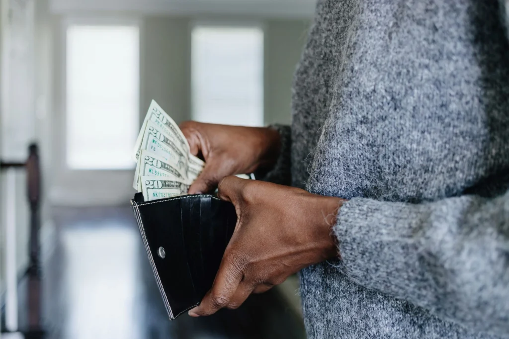 putting money in wallet