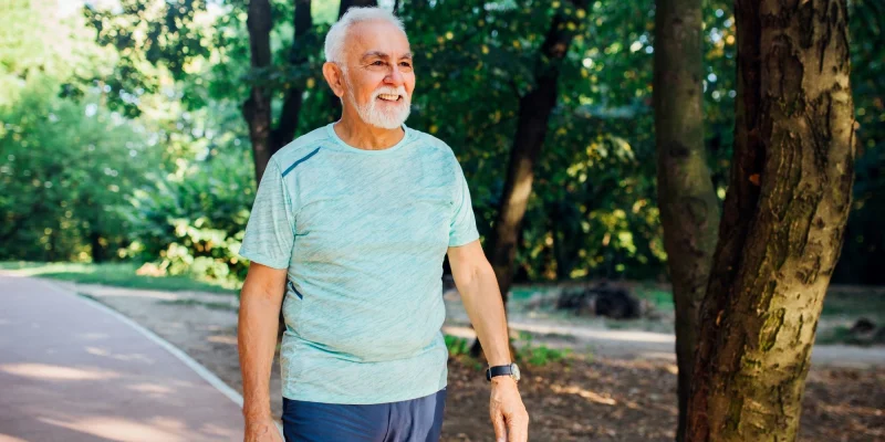 senior man walking along a trail