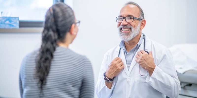 smiling doctor with a patient talking