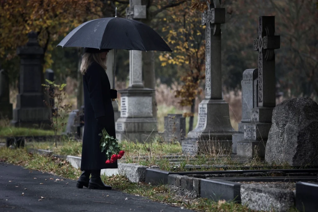 widow grieving at the cemetery