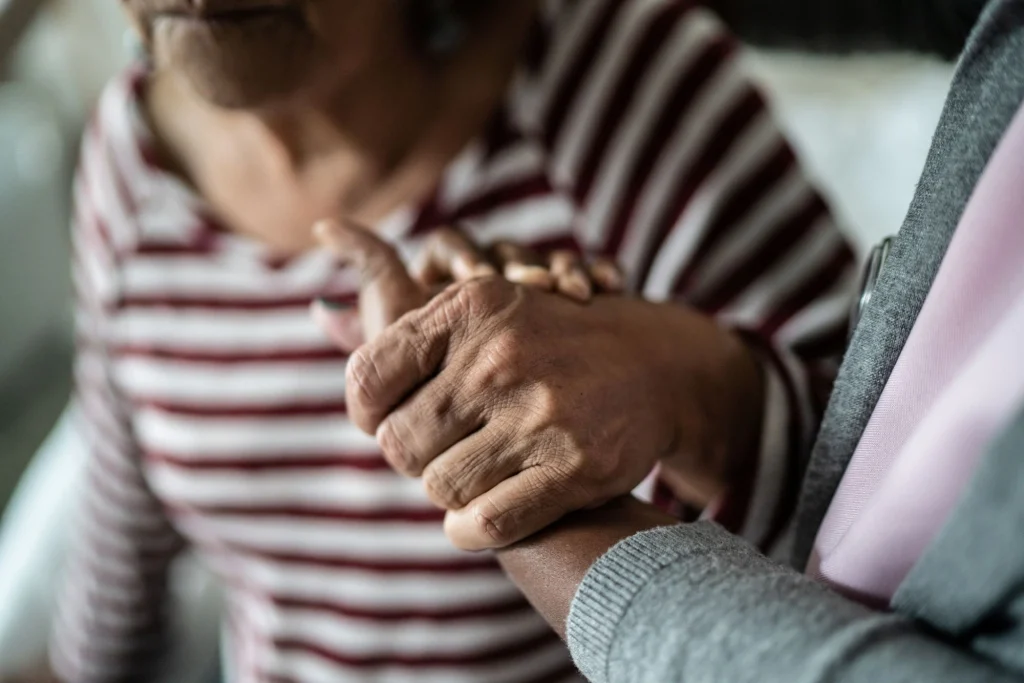 caregiver holding hands with patient