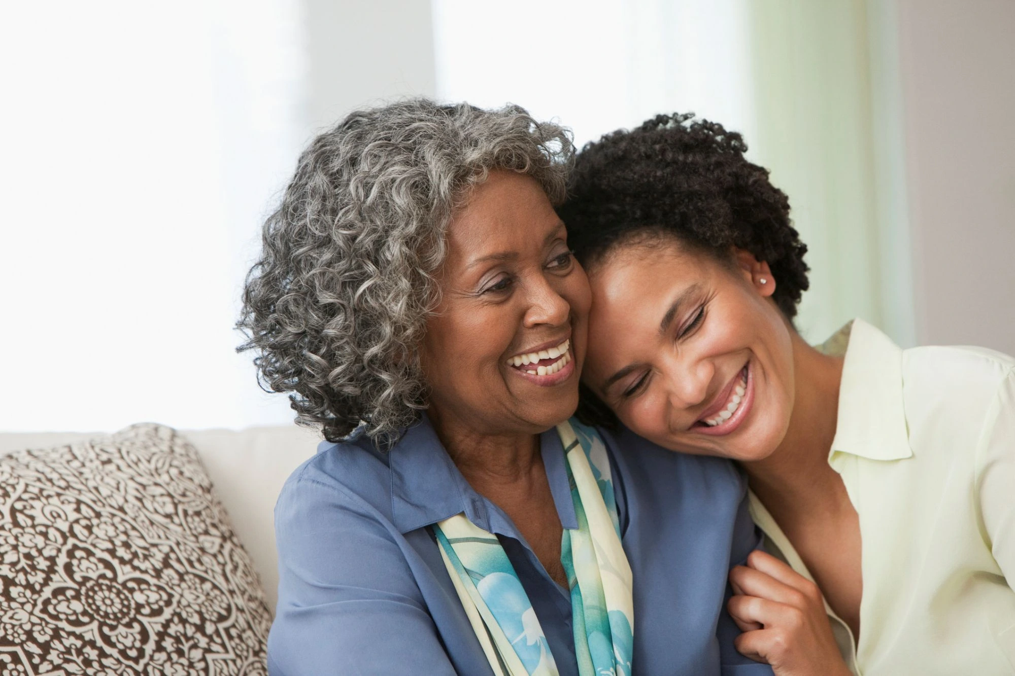 mom and daughter hugging on the couch