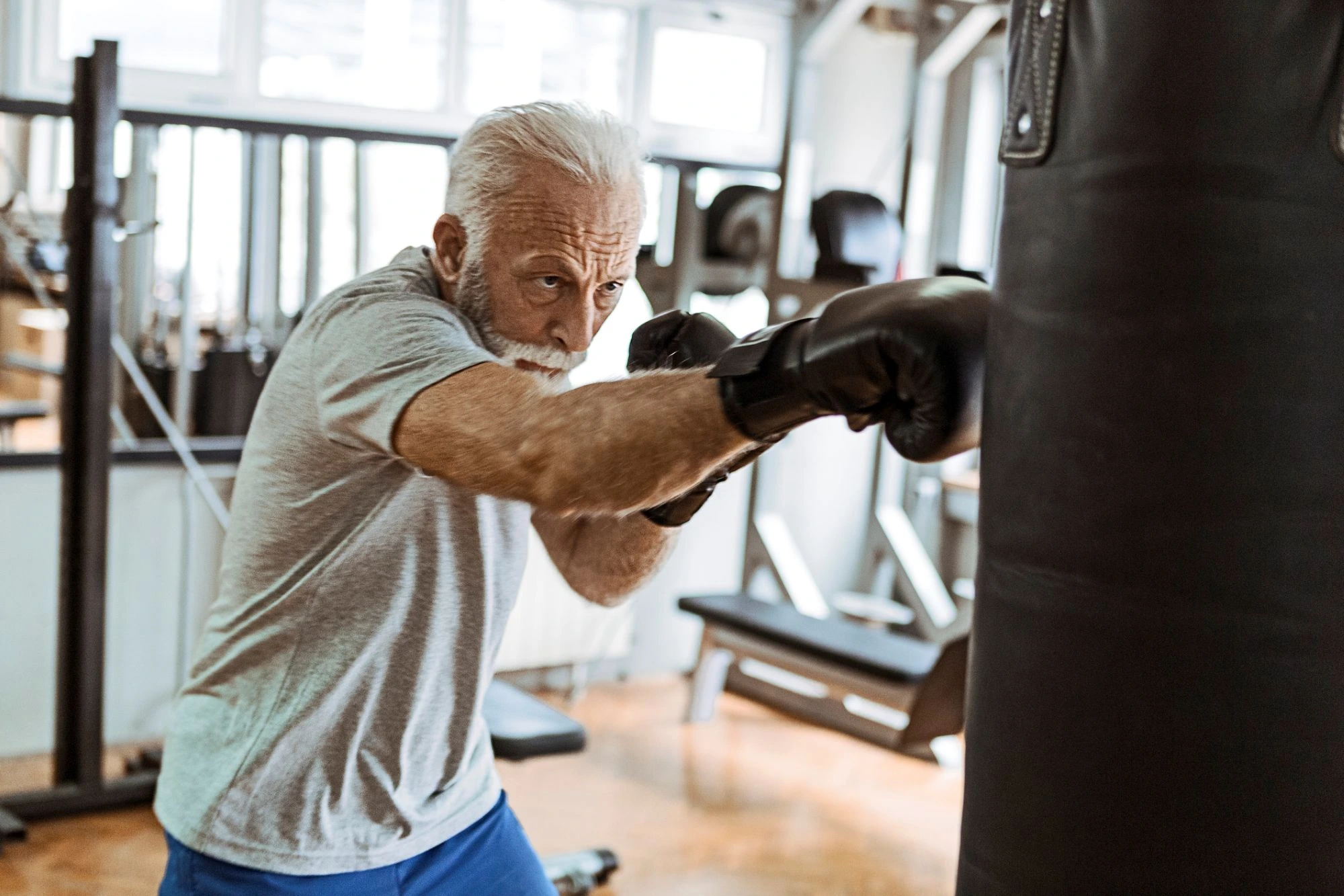 older man training at the gym boxing