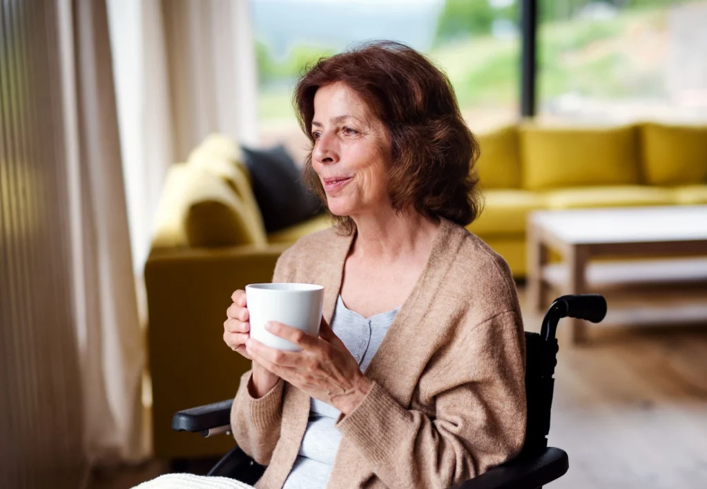 senior woman in a wheelchair drinking coffee