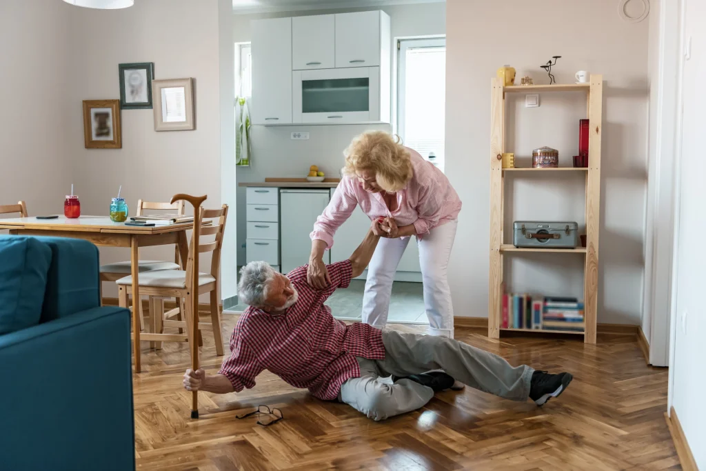 senior man falling and wife trying to pick him up probably from a stroke