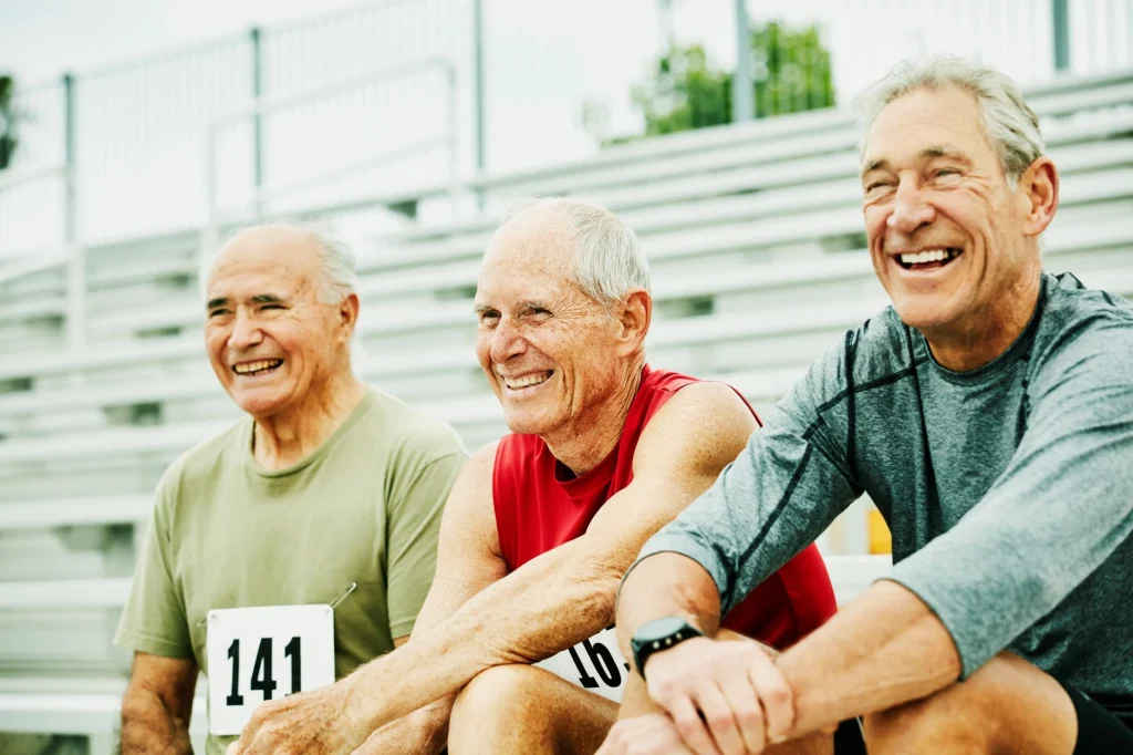 older men sitting on bleachers