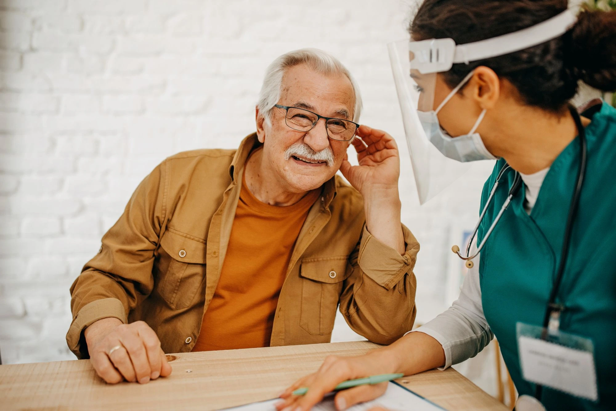 man talking to a nurse hearing test